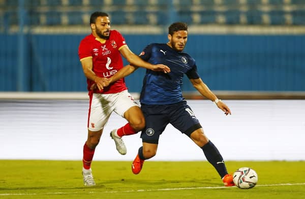 Soccer Football - Egyptian Premier League - Pyramids FC v Al Ahly - 30 June Stadium, Cairo, Egypt - January 26, 2021 Pyramids FC's Ramadan Sobhi in action with Al Ahly's Ahmed Ramadan REUTERS/Amr Abdallah Dalsh