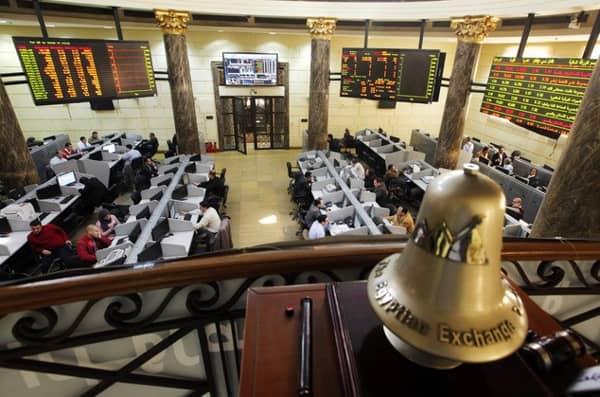 FILE - In this Saturday, March 10, 2013 file photo, Egyptian traders work on the floor of the stock market in Cairo, Egypt. On Sunday, June 1, 2014, Egypts benchmark index plunged, with a temporary suspension of trading failing to cool a frenzy of selling by investors panicked by a newly proposed government tax on capital gains. The market slide was sparked by an announcement from the finance minister that the government will impose a 10 percent tax on net realized portfolio profit at year end. Profits from the stock market are currently tax-free. (AP Photo/Amr Nabil, File)