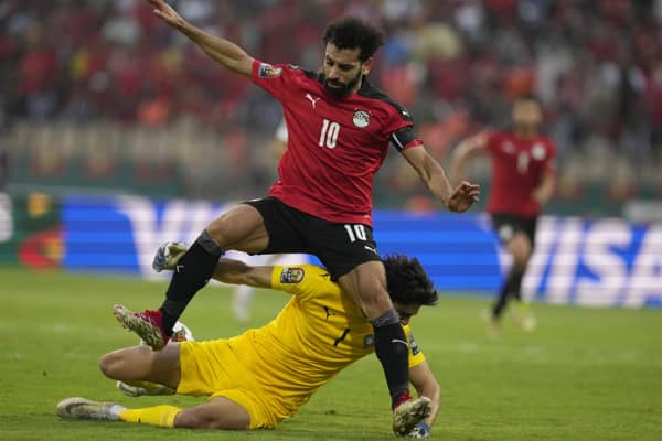 Egypt's Mohamed Salah, top, collides with Morocco's goalkeeper Yassine Bounou, as he attempts a goal shot during the African Cup of Nations 2022 quarter-final soccer match between Egypt and Morocco at the Ahmadou Ahidjo stadium in Yaounde, Cameroon, Sunday, Jan. 30, 2022. (AP Photo/Themba Hadebe)