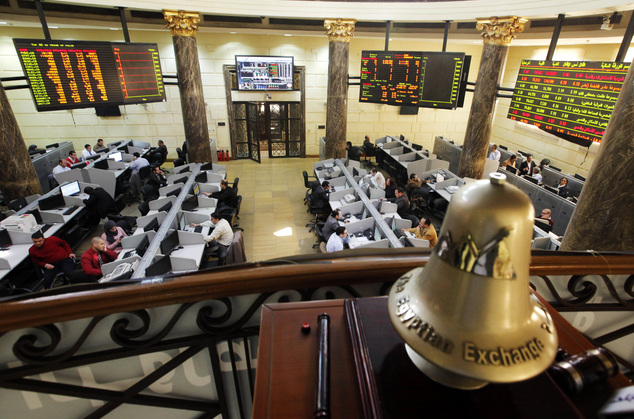 FILE - In this Saturday, March 10, 2013 file photo, Egyptian traders work on the floor of the stock market in Cairo, Egypt. On Sunday, June 1, 2014, Egypts benchmark index plunged, with a temporary suspension of trading failing to cool a frenzy of selling by investors panicked by a newly proposed government tax on capital gains. The market slide was sparked by an announcement from the finance minister that the government will impose a 10 percent tax on net realized portfolio profit at year end. Profits from the stock market are currently tax-free. (AP Photo/Amr Nabil, File)