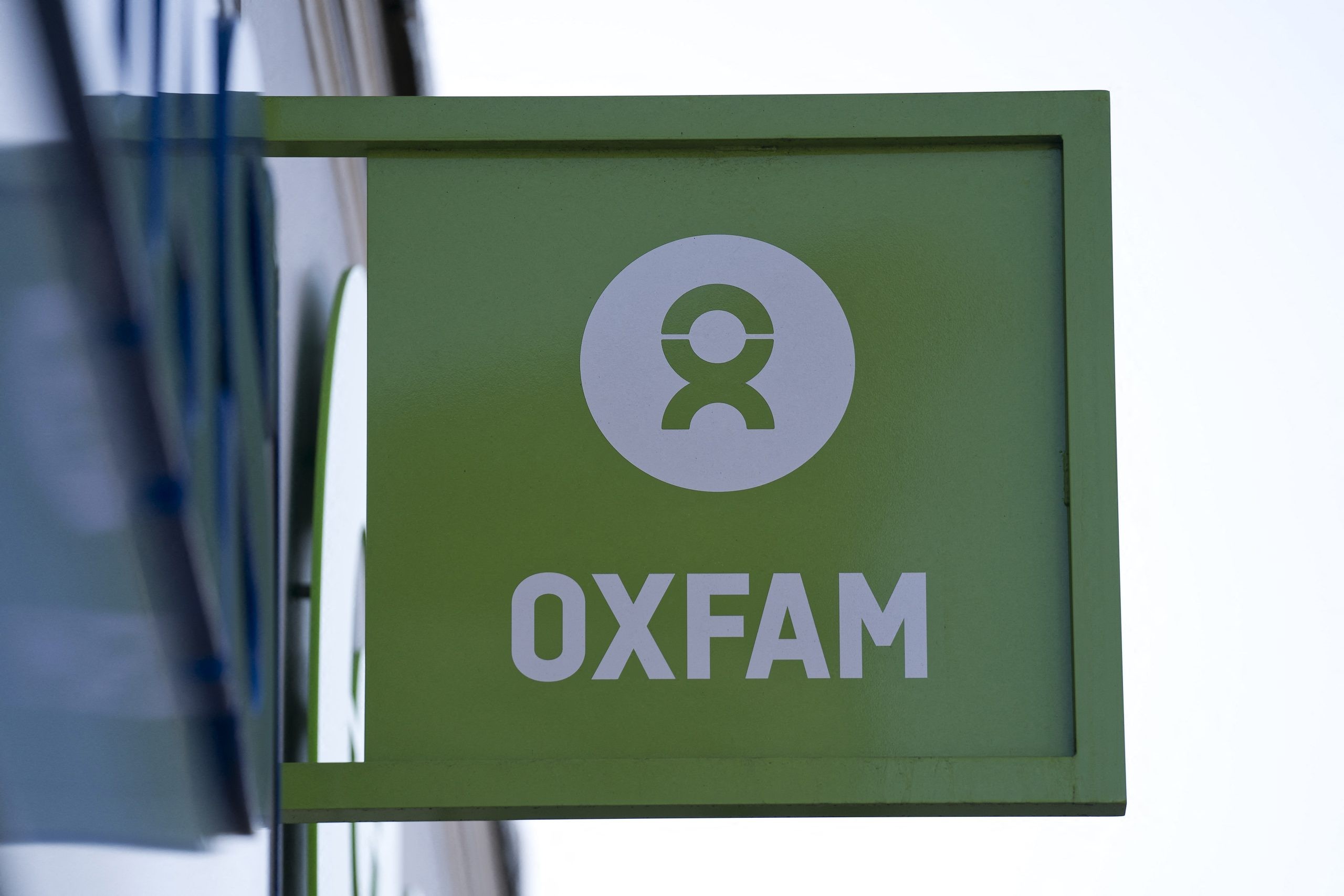 'Oxfam' signage is pictured outside a high street branch of an Oxfam charity shop in south London on February 17, 2018. - Oxfam fired four staff members for gross misconduct and allowed three others to resign following an internal inquiry into what happened in Haiti in 2011. (Photo by Justin TALLIS / AFP)