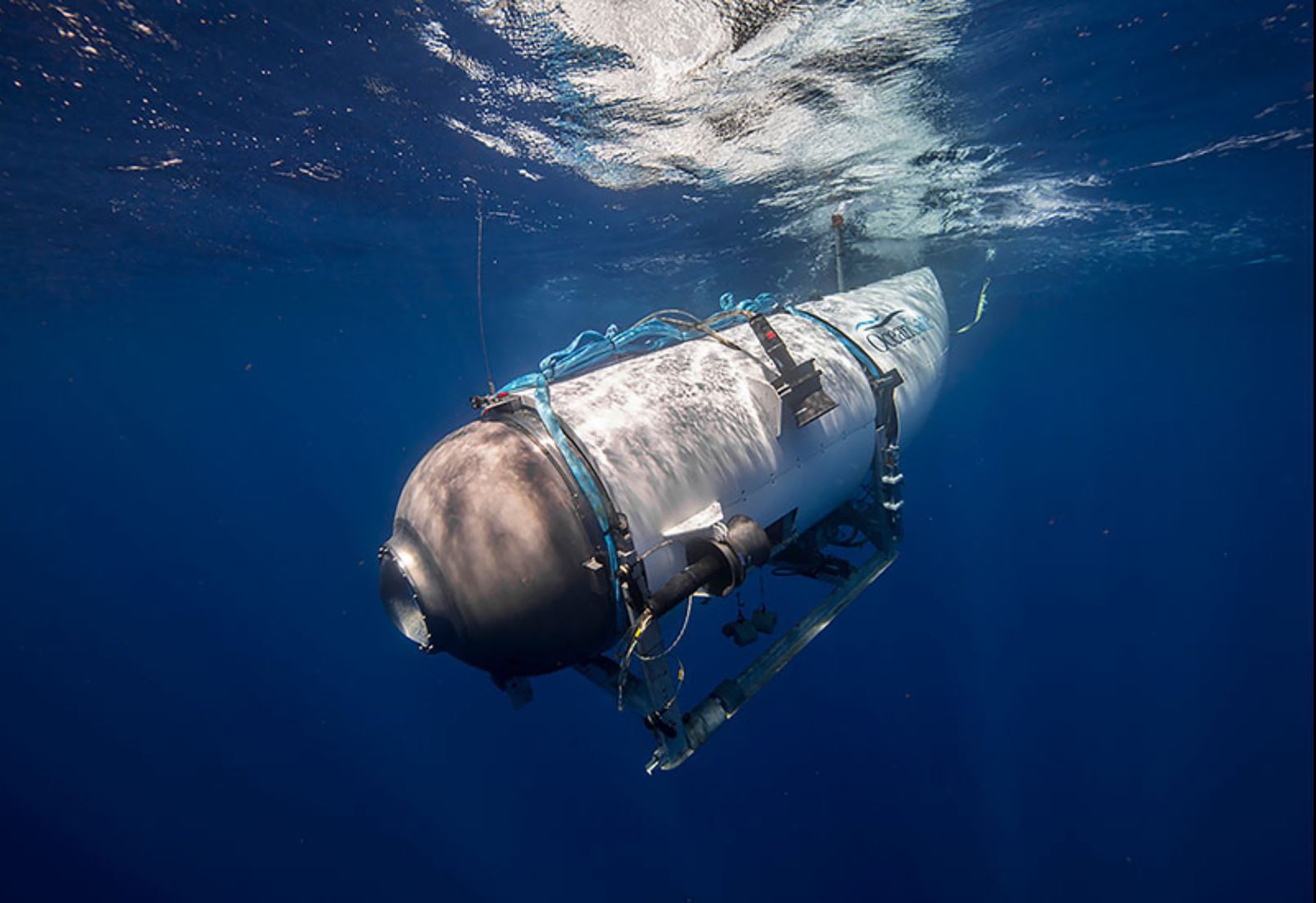 This undated image courtesy of OceanGate Expeditions, shows their Titan submersible beginning a descent. - Rescue teams expanded their search underwater on June 20, 2023, as they raced against time to find a Titan deep-diving tourist submersible that went missing near the wreck of the Titanic with five people on board and limited oxygen. All communication was lost with the 21-foot (6.5-meter) Titan craft during a descent June 18 to the Titanic, which sits at a depth of crushing pressure more than two miles (nearly four kilometers) below the surface of the North Atlantic. (Photo by Handout / OceanGate Expeditions / AFP) / RESTRICTED TO EDITORIAL USE - MANDATORY CREDIT "AFP PHOTO / OCEANGATE EXPEDITIONS" - NO MARKETING NO ADVERTISING CAMPAIGNS - DISTRIBUTED AS A SERVICE TO CLIENTS - RESTRICTED TO EDITORIAL USE - MANDATORY CREDIT "AFP PHOTO / OceanGate Expeditions" - NO MARKETING NO ADVERTISING CAMPAIGNS - DISTRIBUTED AS A SERVICE TO CLIENTS /